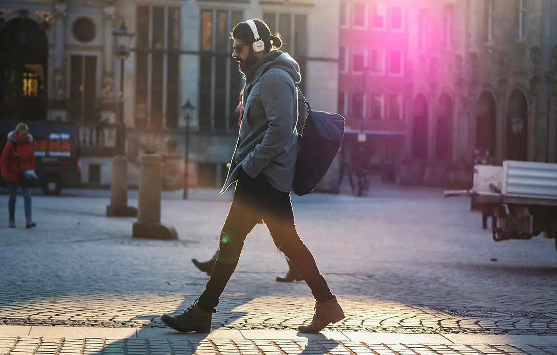 Man walking in the city street with headphones